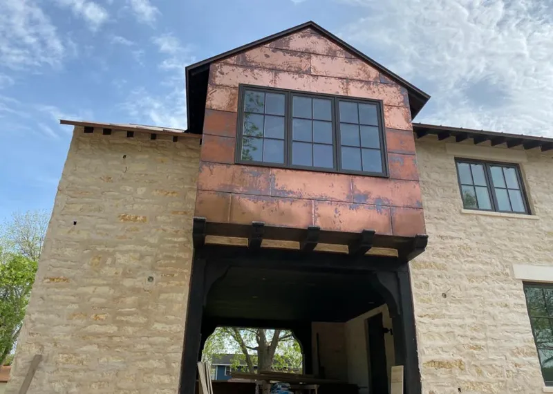 Copper metal panel facade on a stone building for Skylight Installation in Benton